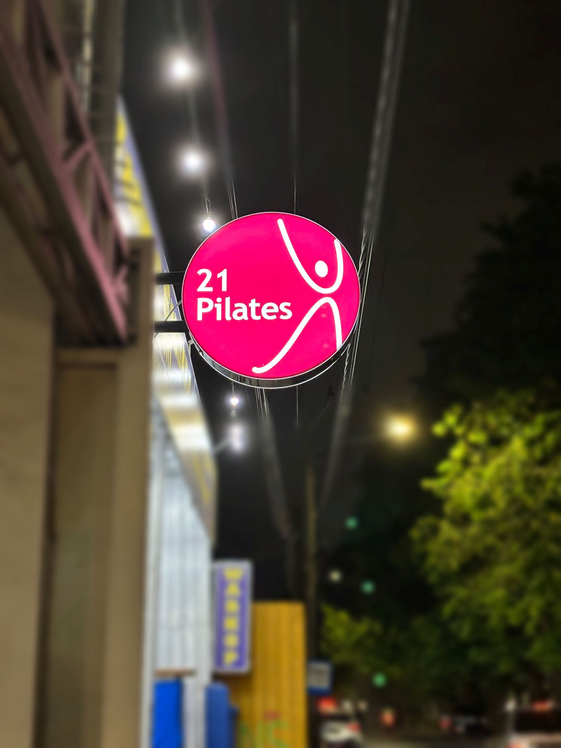 A close up of a person on a pilates reformer machine.