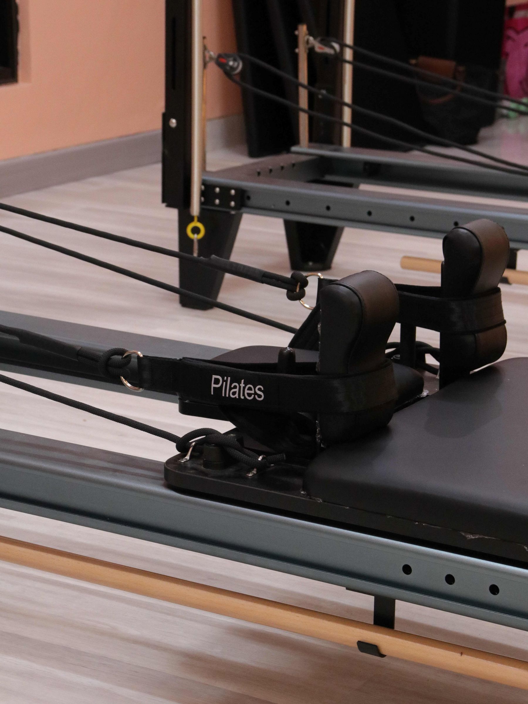 A person stretching on a reformer.